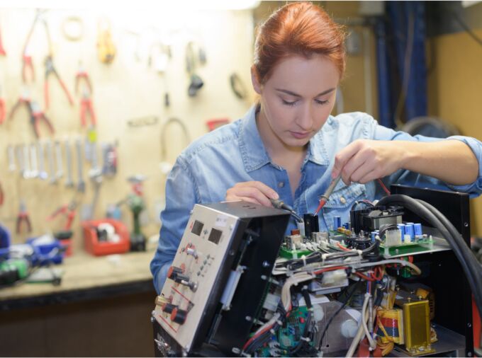 Robotics engineer working on a circuit board.